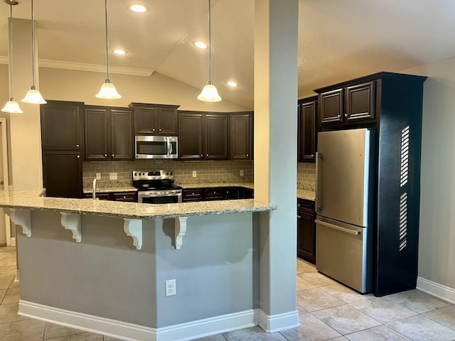 kitchen featuring a kitchen breakfast bar, tasteful backsplash, stainless steel appliances, pendant lighting, and lofted ceiling