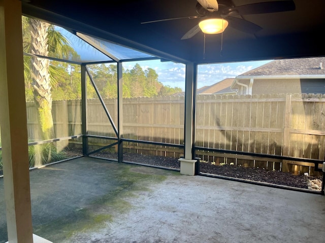 unfurnished sunroom with ceiling fan