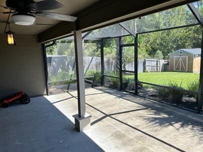 unfurnished sunroom featuring ceiling fan