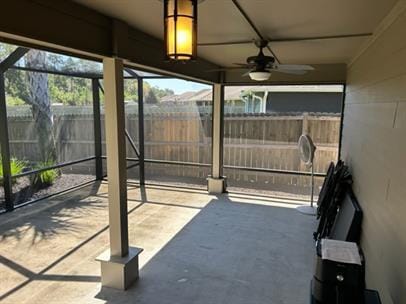 exterior space featuring ceiling fan and glass enclosure