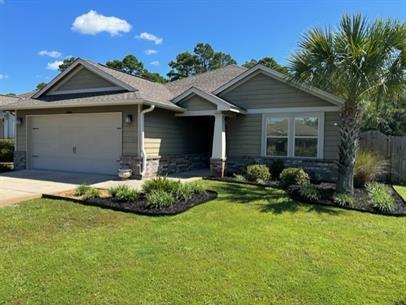 view of front of home with a garage and a front yard