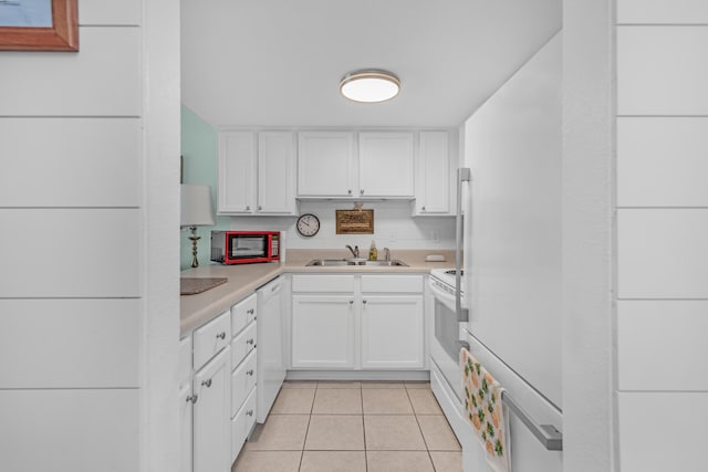 kitchen featuring white cabinetry, white appliances, sink, and light tile patterned floors