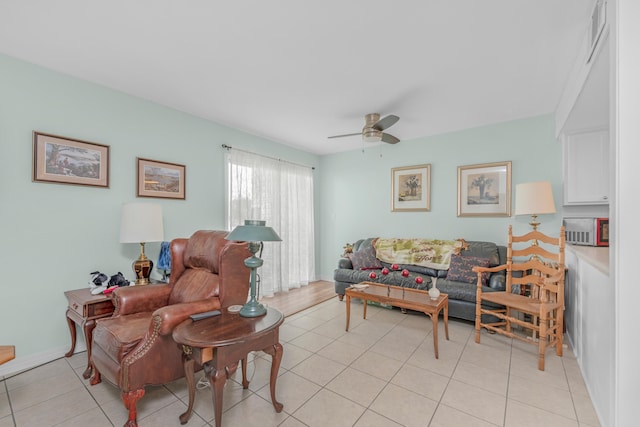 living room with ceiling fan and light tile patterned floors