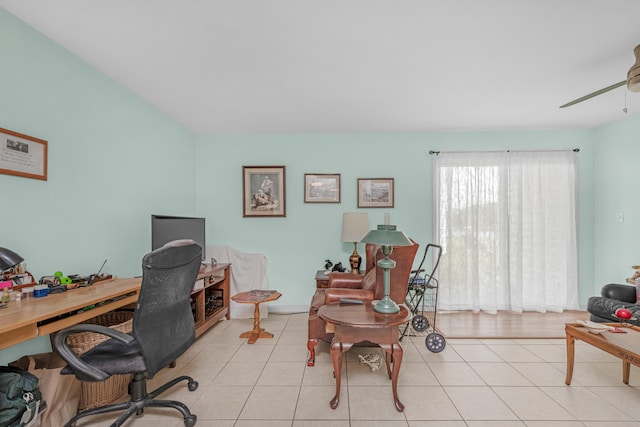 tiled office featuring ceiling fan