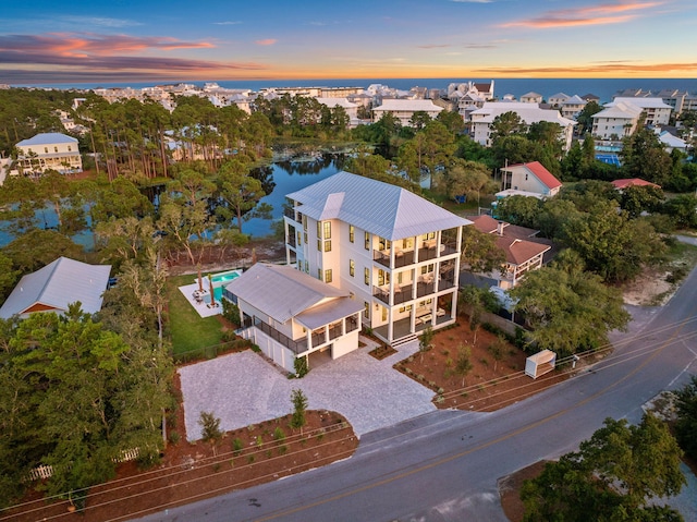 aerial view at dusk with a water view