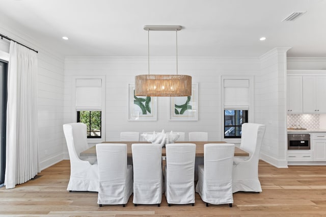 dining space with light hardwood / wood-style flooring