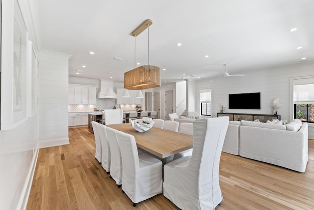 dining area with ceiling fan and light hardwood / wood-style flooring