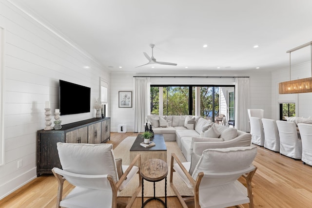 living room with ceiling fan and light wood-type flooring