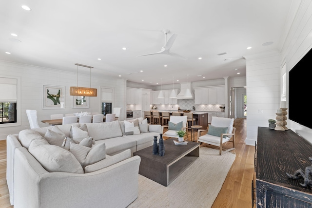 living room featuring ceiling fan and light hardwood / wood-style floors