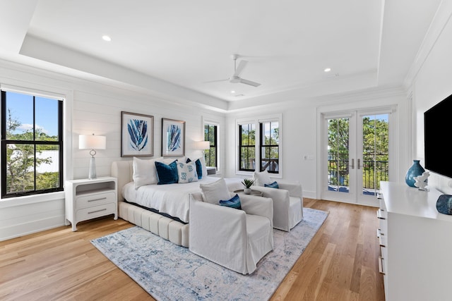 bedroom with access to outside, ceiling fan, multiple windows, and light hardwood / wood-style floors