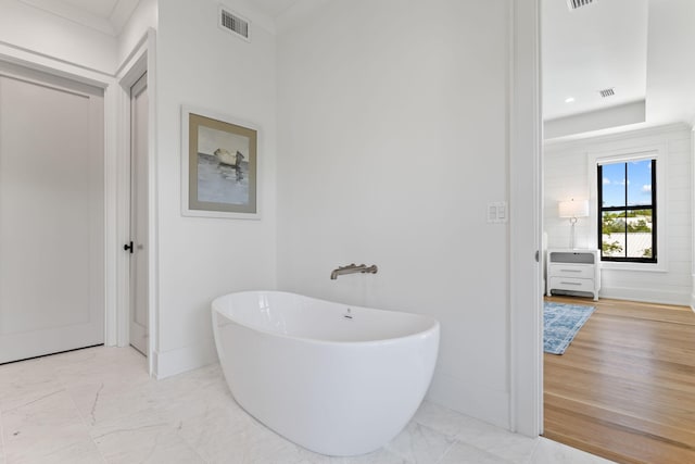 bathroom with wood-type flooring and a washtub