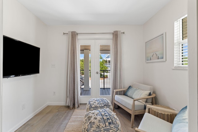 sitting room featuring plenty of natural light and light hardwood / wood-style floors