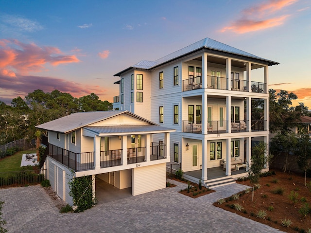 back house at dusk featuring a balcony