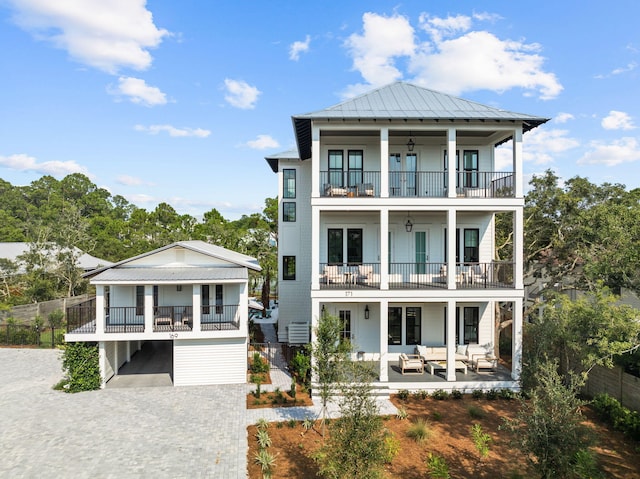 view of front of house with an outdoor hangout area, ceiling fan, a patio, and a balcony