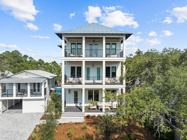 back of property featuring ceiling fan, a balcony, french doors, and a patio area