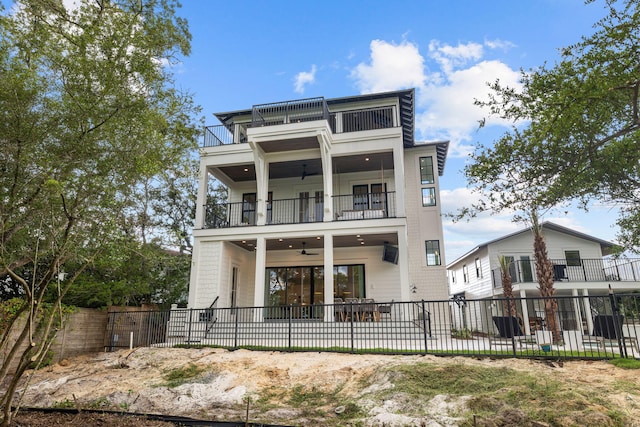 view of front of house with ceiling fan and a balcony