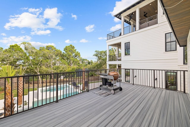 wooden terrace featuring a fenced in pool