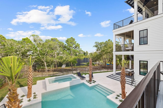 view of swimming pool with a patio and an in ground hot tub