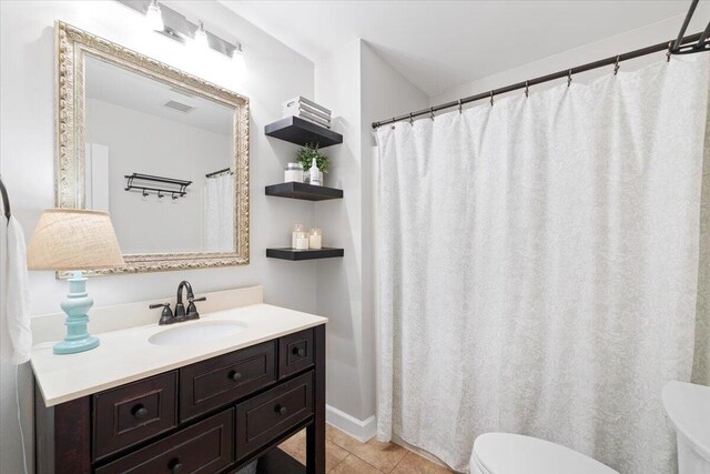 bathroom with vanity, tile patterned floors, and toilet