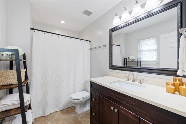 bathroom with vanity and toilet