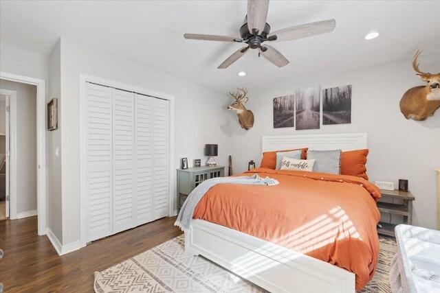 bedroom featuring dark hardwood / wood-style flooring, a closet, and ceiling fan