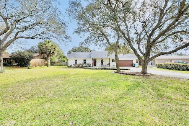 ranch-style home with a garage and a front lawn