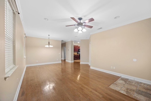 unfurnished living room featuring wood-type flooring, ceiling fan with notable chandelier, and ornamental molding