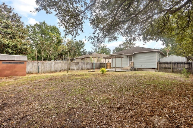 view of yard featuring a patio and a storage shed