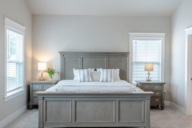 carpeted bedroom with multiple windows