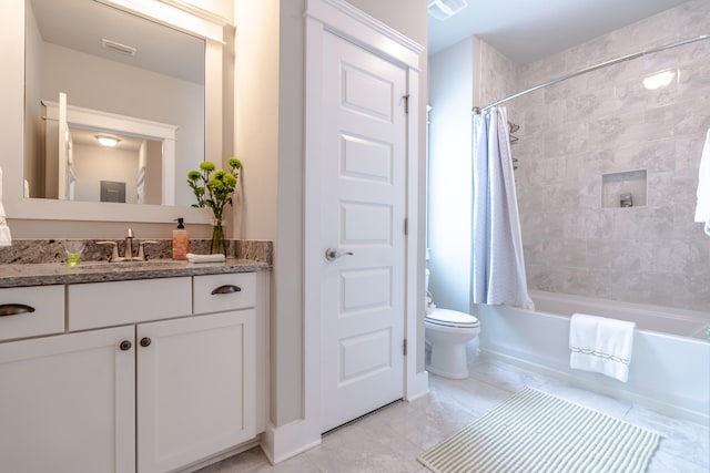 full bathroom with tile patterned flooring, shower / bath combo with shower curtain, vanity, and toilet