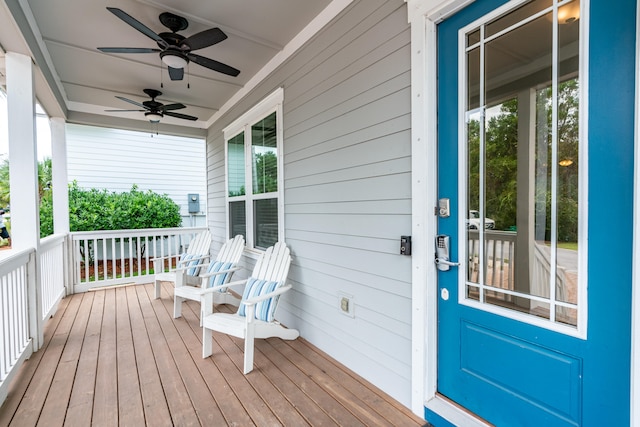 wooden deck featuring a porch and ceiling fan