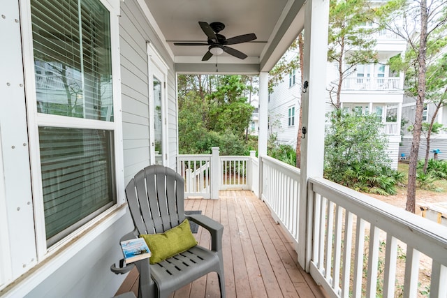 wooden deck with covered porch and ceiling fan