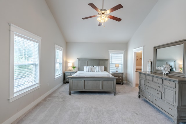 carpeted bedroom featuring ensuite bathroom, high vaulted ceiling, and ceiling fan