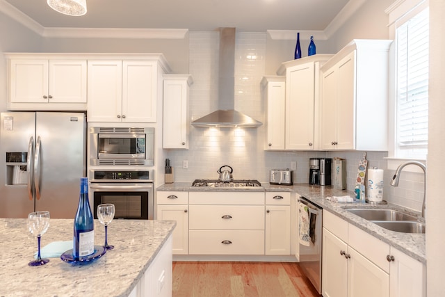 kitchen featuring sink, stainless steel appliances, wall chimney range hood, tasteful backsplash, and crown molding