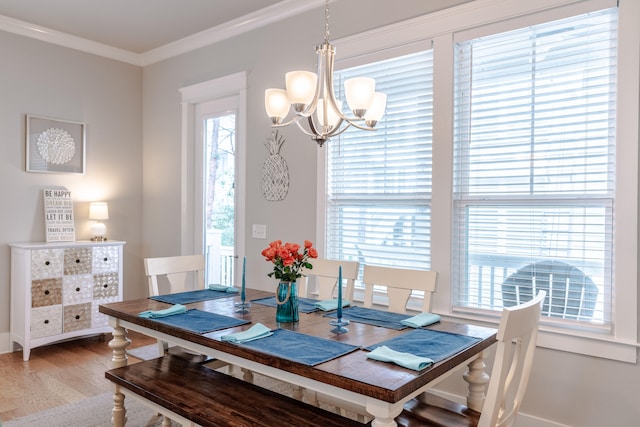 dining space featuring crown molding, plenty of natural light, and hardwood / wood-style flooring