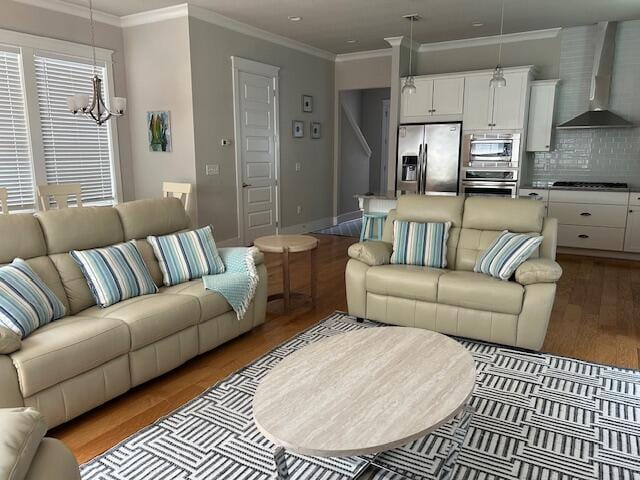 133 Grande Pointe Cir, Inlet Beach, FL 32461 - living room with wood finished floors, a chandelier, and crown molding