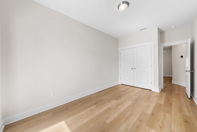 22958 Ann Miller Rd, Panama City Beach, FL 32413 - unfurnished bedroom featuring a closet and light wood-style floors