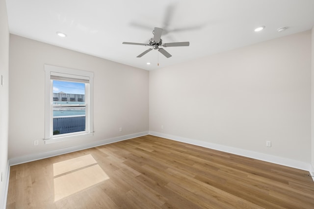 unfurnished room with hardwood / wood-style flooring and ceiling fan