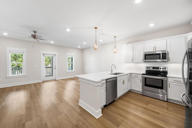 22958 Ann Miller Rd, Panama City Beach, FL 32413 - kitchen with appliances with stainless steel finishes, a peninsula, healthy amount of natural light, open floor plan, and recessed lighting