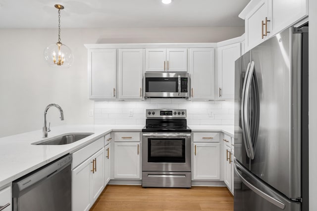 22958 Ann Miller Rd, Panama City Beach, FL 32413 - kitchen featuring appliances with stainless steel finishes, light countertops, white cabinets, backsplash, and recessed lighting