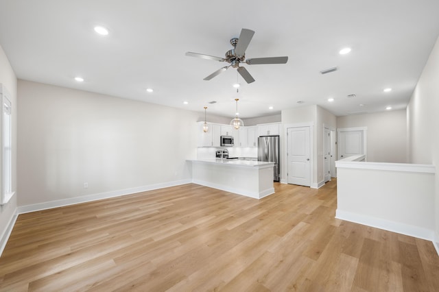 unfurnished living room with ceiling fan and light wood-type flooring