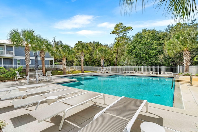 22958 Ann Miller Rd, Panama City Beach, FL 32413 - community pool featuring a patio and view of scattered trees