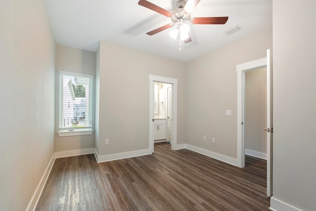 unfurnished bedroom with connected bathroom, ceiling fan, and dark hardwood / wood-style floors