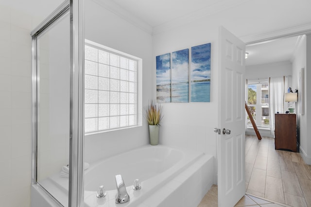 bathroom with a healthy amount of sunlight, shower with separate bathtub, and ornamental molding