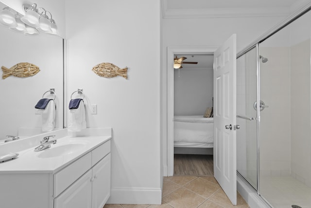 bathroom featuring walk in shower, ceiling fan, vanity, crown molding, and tile patterned floors