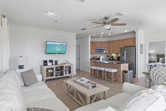 tiled living room featuring ornamental molding and ceiling fan