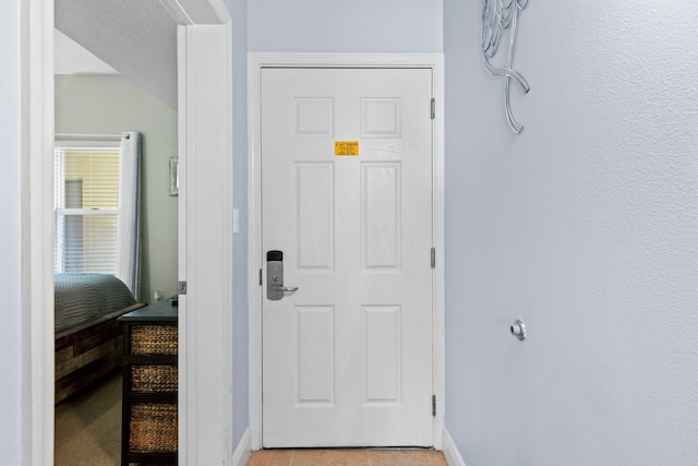 doorway to outside featuring light tile patterned floors