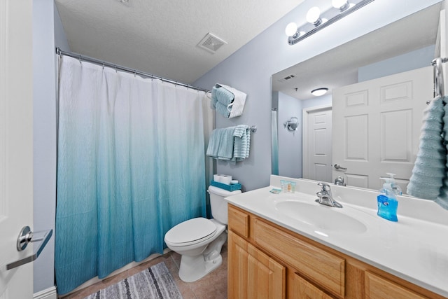 bathroom featuring tile patterned flooring, a shower with curtain, a textured ceiling, vanity, and toilet