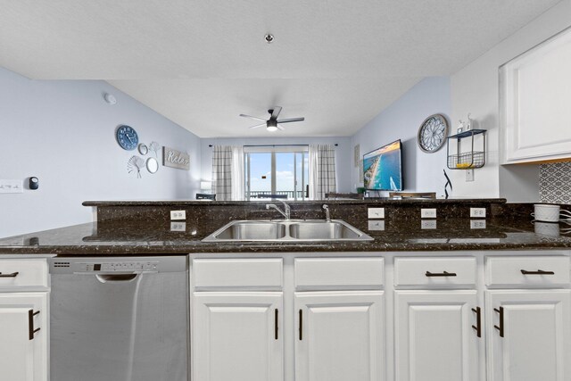 kitchen featuring dark stone counters, white cabinetry, sink, and dishwasher