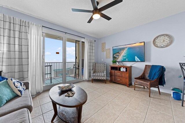 112 Seascape Dr Unit 2206, Miramar Beach, FL 32550 - living area with ceiling fan, light tile patterned flooring, a textured ceiling, and baseboards